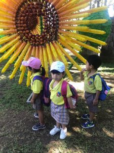 kids in front of sunflower